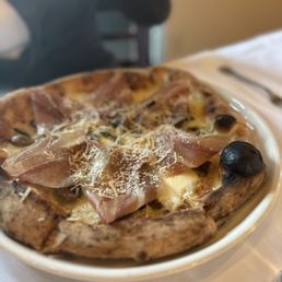 Tavolino Ristorante Italiano signature dishes  Wood-Fired Pizzas, various handmade pasta dishes (e.g., Tagliatelle Bolognese), Osso Buco, Branzino, seasonal Italian specials.